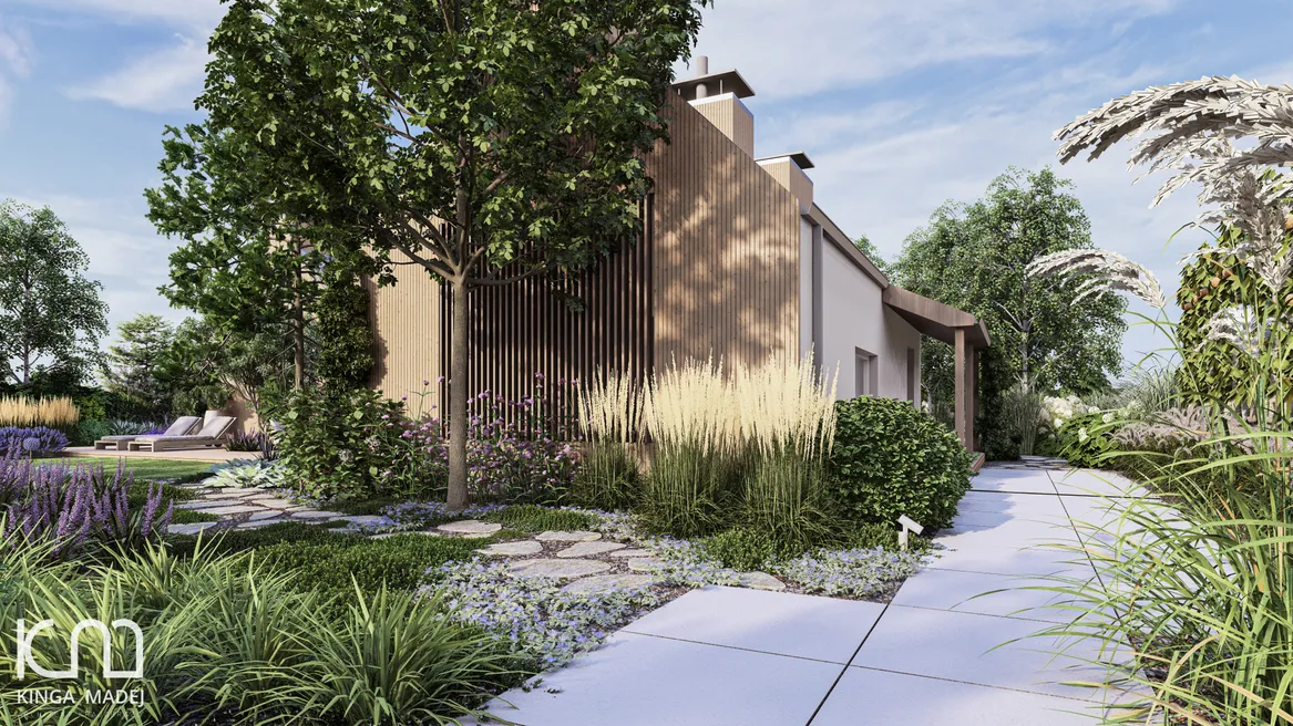 Dwie ścieżki: pierwsza z kamienia polnego prowadząca między rabatami bylinowymi do trawnika i druga, zbudowana z płyt, prowadząca do wejścia głównego