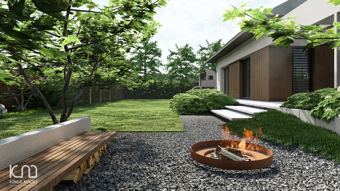 Palenisko z murowaną ławką i składzikiem drewna pod siedziskiem. Widok na duży trawnik i domek zabaw dla dzieci.