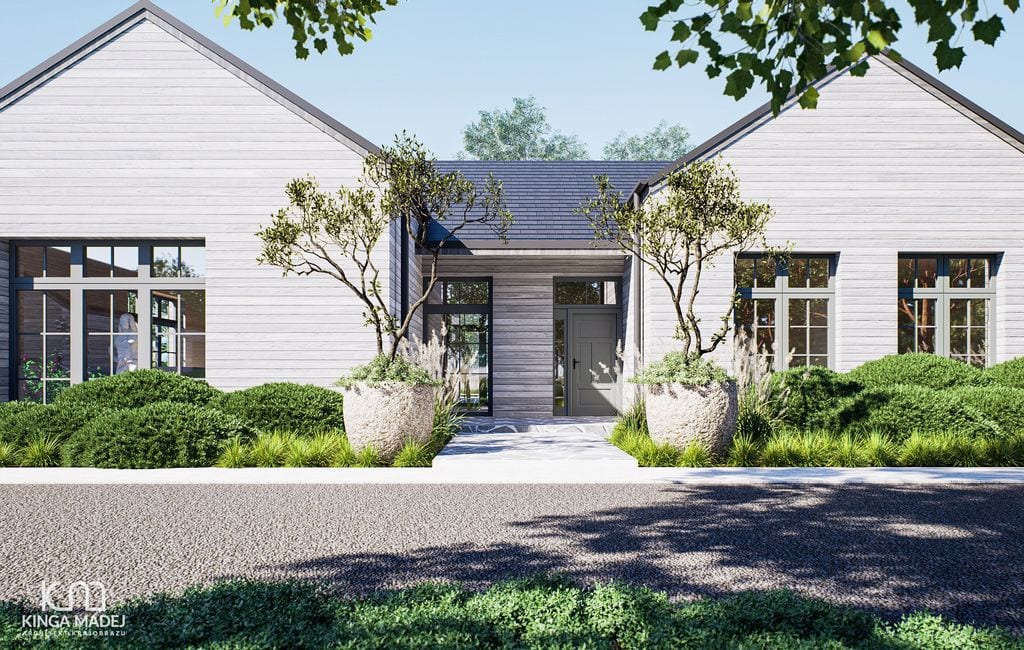 Front z kamiennym tarasem, trawami i ciętymi ostrokrzewami bukszpanowolistnymi